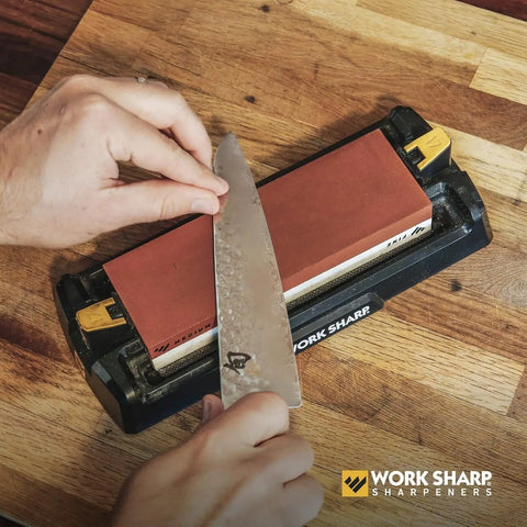 Using Pro Grade Kickass Benchtop Whetstone Knife Sharpener With 1000/6000 Grit Corundum Stones to sharpen a chef's knife.