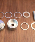 Coin Ring Puncher And Spacer Set For Jewelry Making With Six Spacer Rings In Inner Diameters Of 1.362, 1.276, 1.228, 1.209, 1.047, And 0.957 Inches on wooden table