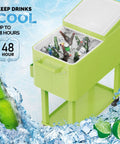 80 Quart Rolling Ice Chest Cooler Cart For Patio Parties And Party Ready Backyard Bar Setup With Folding Shelf And Bottle Opener Light Green Portable Beverage Cooler On Wheels filled with ice and drinks