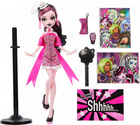 Iconic Design Draculaura Reproduction Doll In A Dope Pink Ruffle Dress featuring accessories and display stand.