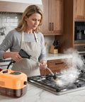 Heavy Duty 2500W Handheld Steam Cleaner With 4.5 Bar High Pressure For Kitchens And Bathrooms in use on a stovetop.