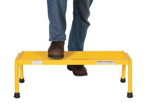 Person stepping on Aluminum 1 Step Wide Stand With 500 Lb Capacity In Bright Yellow For Industrial And Commercial Use, Lightweight Yet Durable