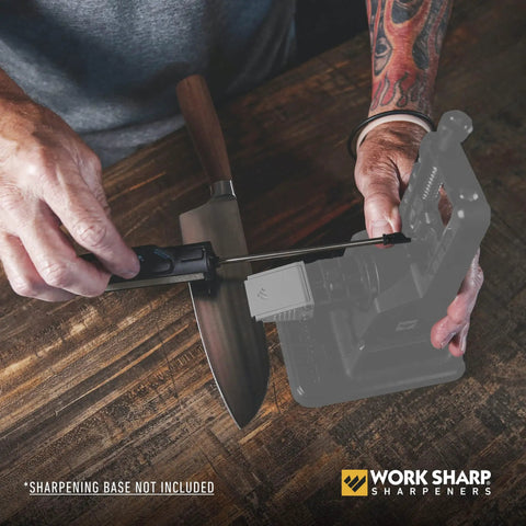 Person using Upgrade Kit For WSBCHPAJ Knife Sharpener With Seven Abrasives to sharpen a knife on a wooden table.