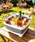 Collapsible Dish Basin With Drain Plug 2.4 Gal Foldable Sink for Kitchen RV Camping holding ice and drinks at outdoor party in gray.