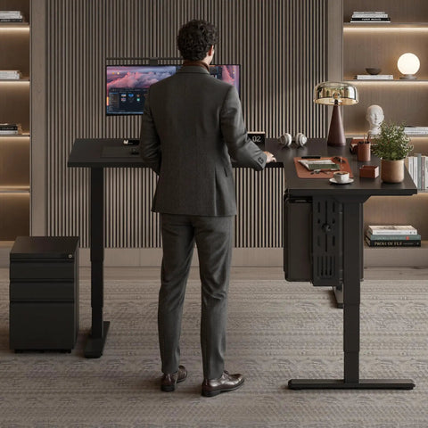 Man in suit using Rock Solid L Shaped Electric Standing Desk Triple Motor Height Adjustable Corner Workstation Sixty Three Inch.
