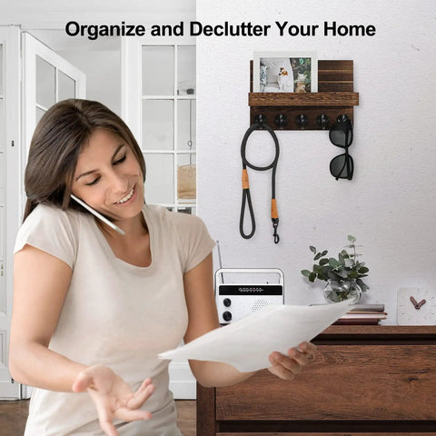 Wall Mounted Key And Mail Organizer With Shelf And Large Hooks For Keys Bags Coats And Leashes Keeps Your Essentials In One Spot Paulownia Wood Key Hanger With Mounting Hardware Brown Finish Durable Entryway Organizer installed on wall with woman organizing.