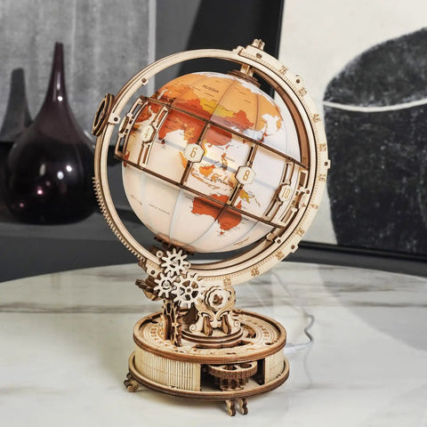 Illuminated Globe 3D Wooden Puzzle With Stand For Adults 180 Piece Build Built In LED Model Kit Cool Hobby Gift Home Decor Dorm Room Accent Relaxing Night Light on a marble table.