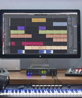 Home studio setup with USB-C 6x4 Audio Interface With Pro-Grade Studio-Quality Sound And ESS Sabre32 DAC, computer, and speakers.