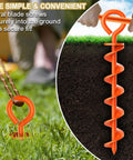 Corkscrew ground anchor in use, steel with orange wind rope, part of Beefy Heavy Duty Canopy Tent Stakes And Dog Tie Out Stakes Set.