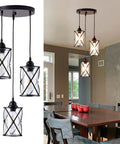 Dope Three Light Industrial Pendant Light With Black Metal Cage And Glass Shades in dining room setup