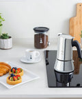New Venus Induction Stovetop Coffee Maker 6 Cup Stainless Steel Silver on induction cooktop in modern kitchen setting