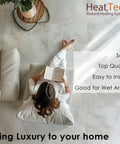 Woman sitting on a sofa reading, showcasing 20 Sq Ft Electric Radiant Floor Heating Cable Kit With Programmable Thermostat For Tile Stone And Laminate Floors 120V Underfloor Heating System Plug And Play Setup With All Included Accessories.