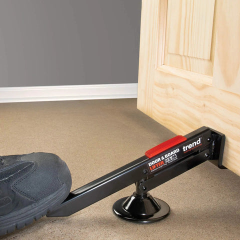 Swivel Type Door And Board Lifter With Hands Free Foot Operated Lift for Doors Panels and Plasterboard in use on wooden door