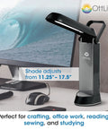 Folding Task Lamp With Multi Position Shade Portable Desk Light For Your Desk Setup Home Office Low Heat And Low Glare Fold Up Design With Handy Handle Fits Desks And Workstations White Finish on a desk setup with computer screen.