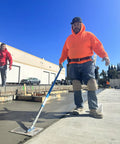 Worker using trowel on concrete wearing Leatherhead Kneepads With Ultra Soft Cushioning For Knee Fatigue Reduction, Non Slip Neoprene Straps
