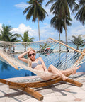 12 Ft Double Rope Hammock With 13 Ft Brown Wooden Arc Stand For Outdoor Patio And Poolside Chill Session, 2 Person Hand Woven Cotton Hammock With Spreader Bar, Natural Color, 450 Lbs Capacity by a pool