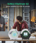 Filament Dryer S2 for 3D Printer, 70 Degree C Max, in black and white options displayed in a workshop setting with two people discussing.