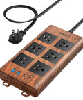 Slick Wood Finish Surge Protector Power Strip With Six Widely Spaced Outlets And Dual USB C Plus Dual USB A Ports on a desk.