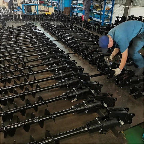 Worker assembling Hydraulic Earth Auger For Mini Excavator Backhoe Post Hole Digger Attachment For Fencing Landscaping And Construction Projects With Pro Grade Torque For Drilling Through Tough Soil.