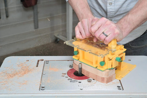 Person using Grr-Rip Block 3D Pushblock System for Table Saws, Smart Pushblock with Gravity Heel on a woodworking router table.