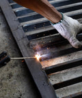 Close-up of welding a 304 stainless steel flat bar (1/8 in thick x 1 3/16 in wide x 11 3/4 in long) with brushed finish.