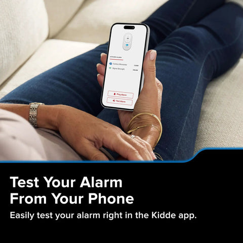 Person testing Smart Carbon Monoxide Detector With Plug In Design And AA Battery Backup, Real Time Notifications, 2.4 GHz Wi Fi Enabled on phone