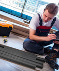 Pro Grade Foam Backer Rods 12 Pack For Expansion Joints, black foam rods on floor with workman reviewing plans.