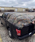 No Nonsense Tough 9 Mil Tarp Cover Waterproof UV Resistant Tarpaulin for Outdoor Use on truck, camo design, secured with straps