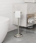 Free Standing Toilet Paper Holder With Pivoting Post, Brushed Nickel Finish, next to bathroom wall, measures 22 inches, supports mega roll