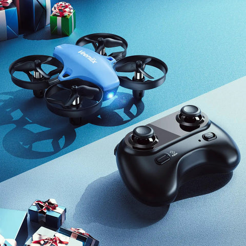 Mini Drone For Kids And Beginners With 3 Batteries, Indoor RC Quadcopter next to remote control on blue surface with gifts