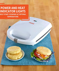 Imusa 4 Slot Electric Arepa Maker, 1200 Watt Nonstick Griddle For Fluffy Corn Cakes with cooked corn cakes and lettuce sandwich.