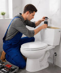 Man installing a Heavy Duty Eight Count Toilet Fill Valve Replacement Kit Black Adjustable Flushing Tank Refill Stopper Assembly.