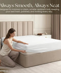 Woman fitting a Buttery Soft Organic Cotton Queen Fitted Sheet Featuring 12 Inch Deep Pockets on a bed.