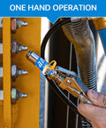 Locking grease gun coupler attached to a grease nozzle on yellow industrial equipment with bolts; metal chrome finish.