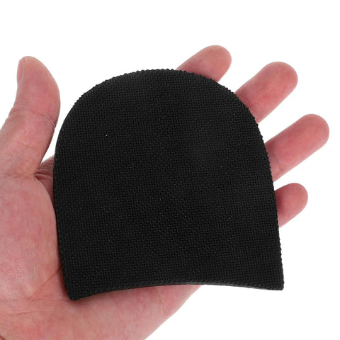 Person holding a black rubber heel pad for sneakers and boots non slip shoe sole protector cushion anti slip heel repair patch for men and women footwear easy to attach adhesive not included all day comfort.