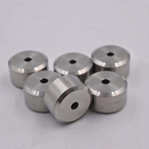 Six silver aluminum spacers with central holes, front view