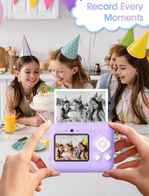 Children at a party enjoying cake with instant print camera showing photo; 12 Roll Kids Camera Paper Roll Refills Two Point Two Inch By 20 Foot Thermal Paper For Instant Print Cameras And Mini Sticker Printers White Premium Photo Paper Each Roll Yields 75 To 90 Photos.