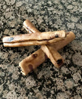 Beefhide Chip Rolls 5 Inch Dog Chew Treats Peanut Butter Flavor Made in USA 100 Percent Natural Rawhide on stone surface