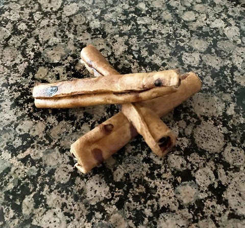 Beefhide Chip Rolls 5 Inch Dog Chew Treats Peanut Butter Flavor Made in USA 100 Percent Natural Rawhide on stone surface