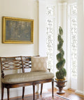 Self-Adhesive Privacy Glass Window Film In Bamboo White Pattern, 17 By 78 Inch Roll on tall windows by a bench in a home setting.