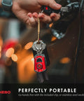 Person holding keys with attached Mycro Keychain Flashlight 400 Lumen Rechargeable EDC Light With 6 Red Green White Modes.