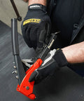 Person using General Utility Work Gloves GUG All Purpose Performance Fit Durable Machine Washable Small Black With Thermoplastic Rubber Knuckle Protection while handling tool.