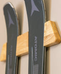 Close-up of two skis on a Horizontal Wood Ski Rack Wall Mount For Home Garage Cabin Heavy Duty Ski Wall Organizer And Display Shelf