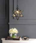 12-Inch Oil Rubbed Bronze Moravian Star LED Pendant Light With Clear Glass hanging above a table in a modern room