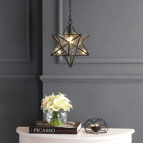 12-Inch Oil Rubbed Bronze Moravian Star LED Pendant Light With Clear Glass hanging above a table in a modern room