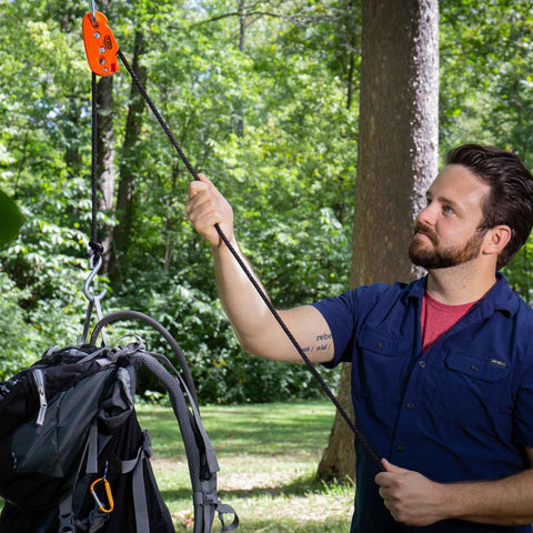 Man using One Quarter Inch Medium Duty Tie Down System With Fifteen Foot Rope Weather Resistant 150 Lbs Working Load Jam Cleat