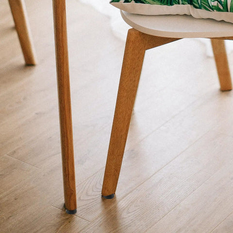 Non Slip Furniture Feet Pads 20pcs Set on chair legs, preventing floor scratches and slippage with stable surface contact indoors.
