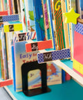 Library books with colorful index tabs, featuring black stripe washi craft tape, 6-roll pack, 0.59 in x 393 in adhesive decorative paper masking tape.