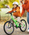 Boy on a green bike with 180 pieces colorful bike wheel spoke beads clips for kids bicycle spoke decorations outdoors