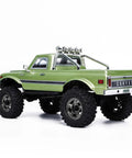 Badass 1/18 Scale RC Crawler With Slick Shifting Two Speed Transmission And Bulletproof Metal Gears Nasty Terrain Rock Climbing Rig Trail Smashin Setup Drop In Ready Convoy Medium Olive Green rear view showcasing rugged tires and chrome accents.